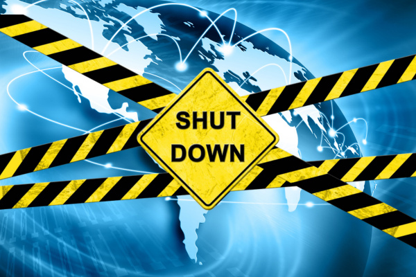 A striking image featuring the planet Earth enveloped in caution tape, prominently displaying the words 'Shut Down' symbolizing a global crisis or breakdown.